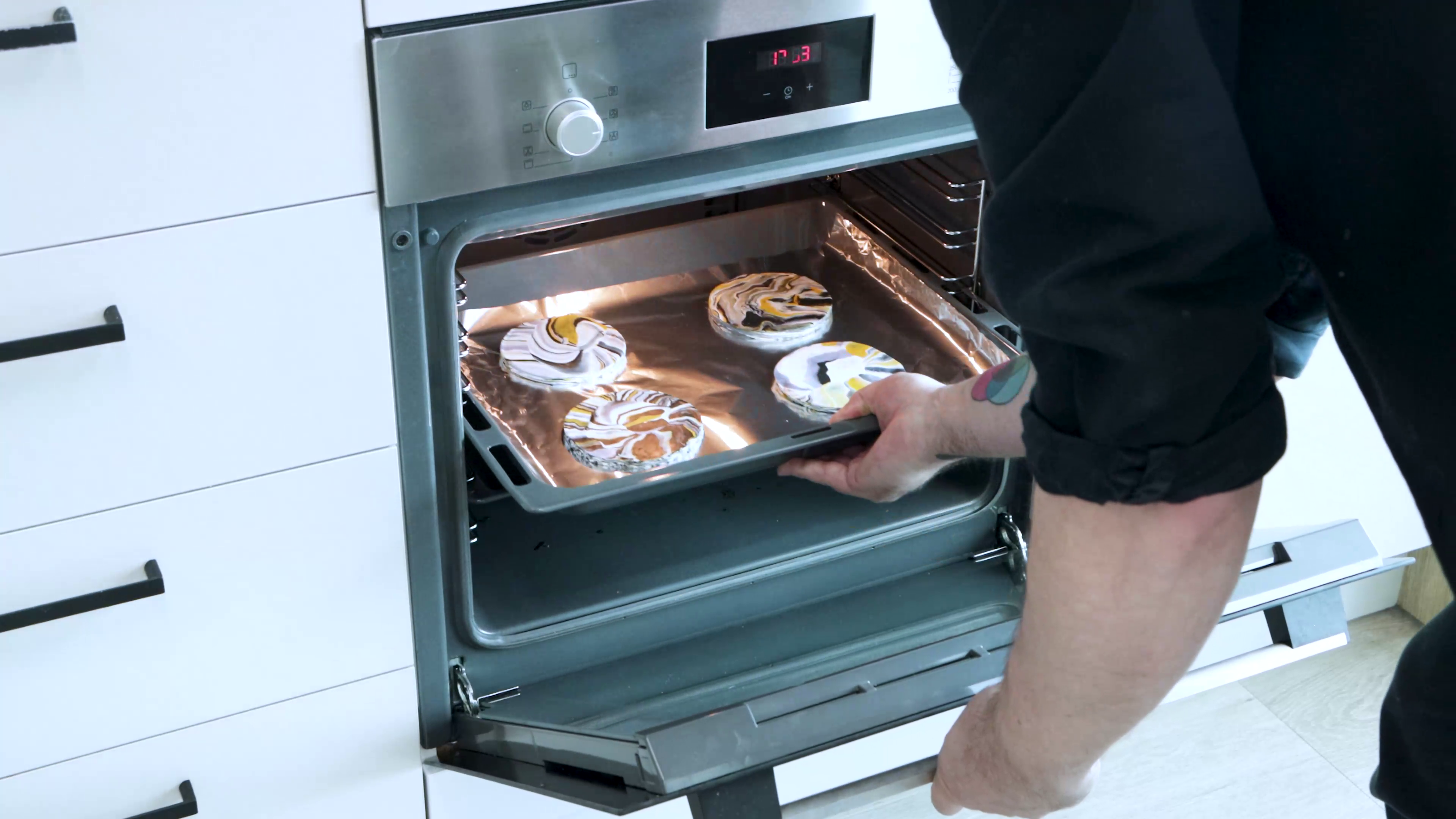 Putting tray with 4 marble coasters into oven