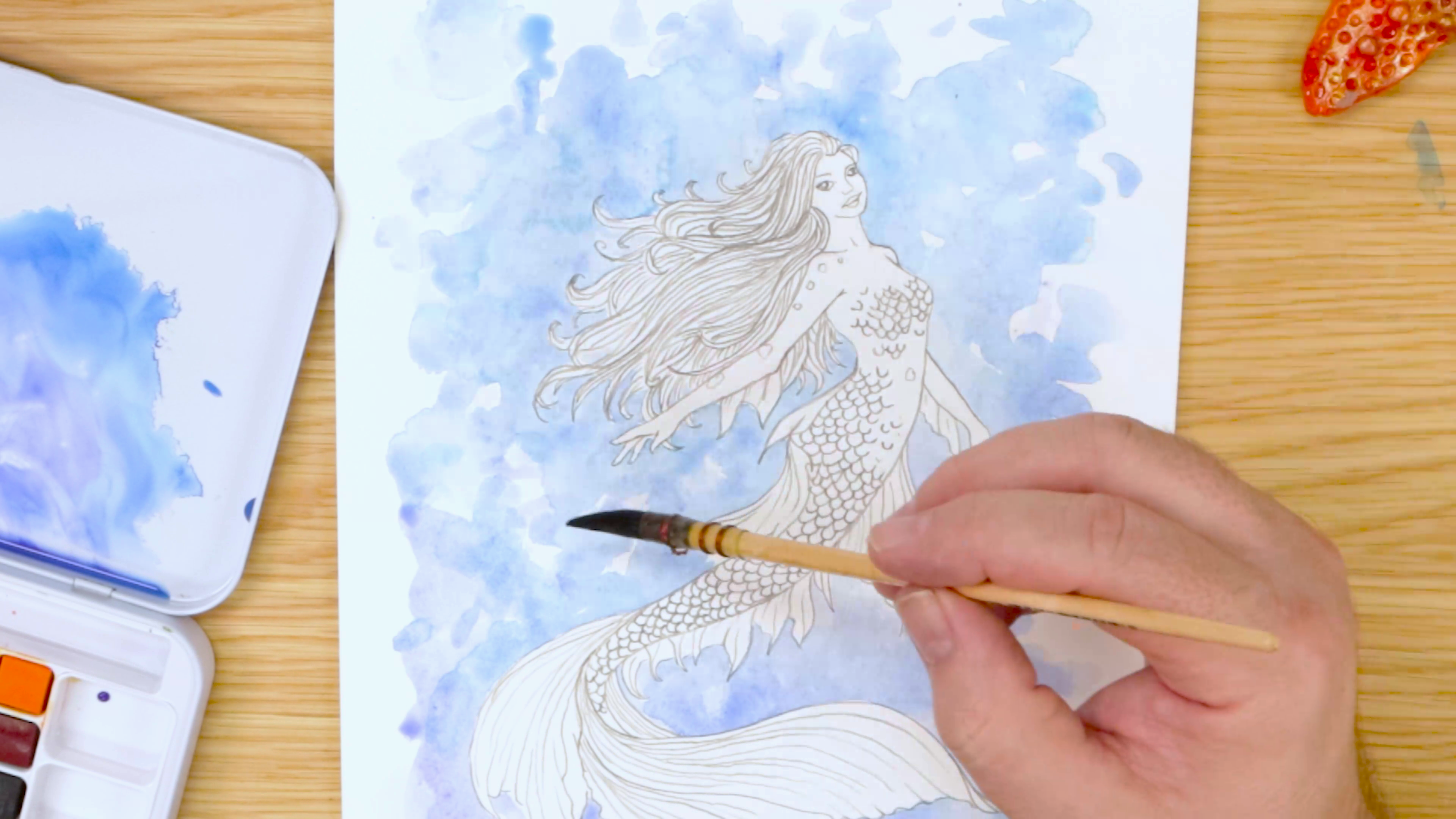 Painting blue background for mermaid pencil drawing