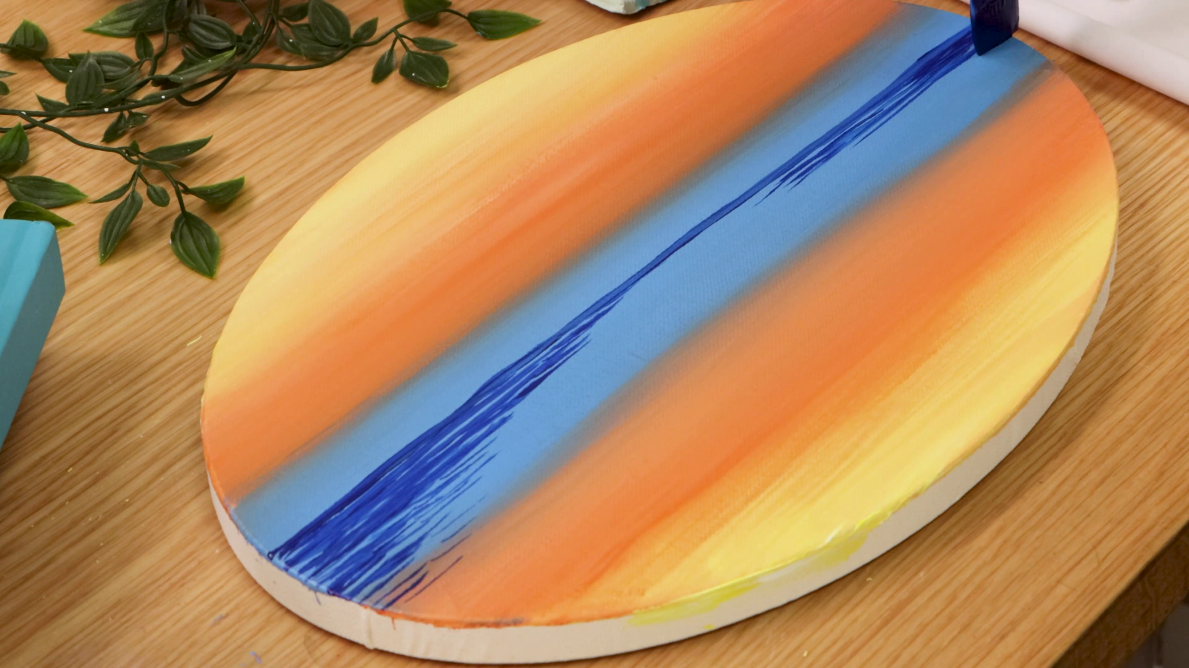 Painting horizon line and water on oval sunset