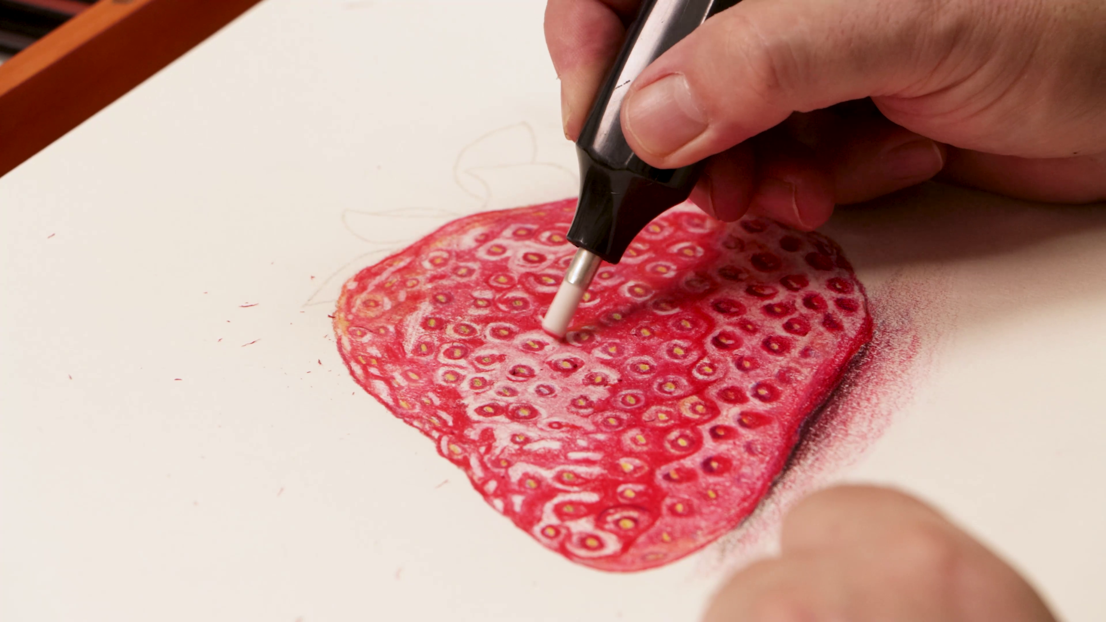 Lifting highlights on strawberry art with electric eraser