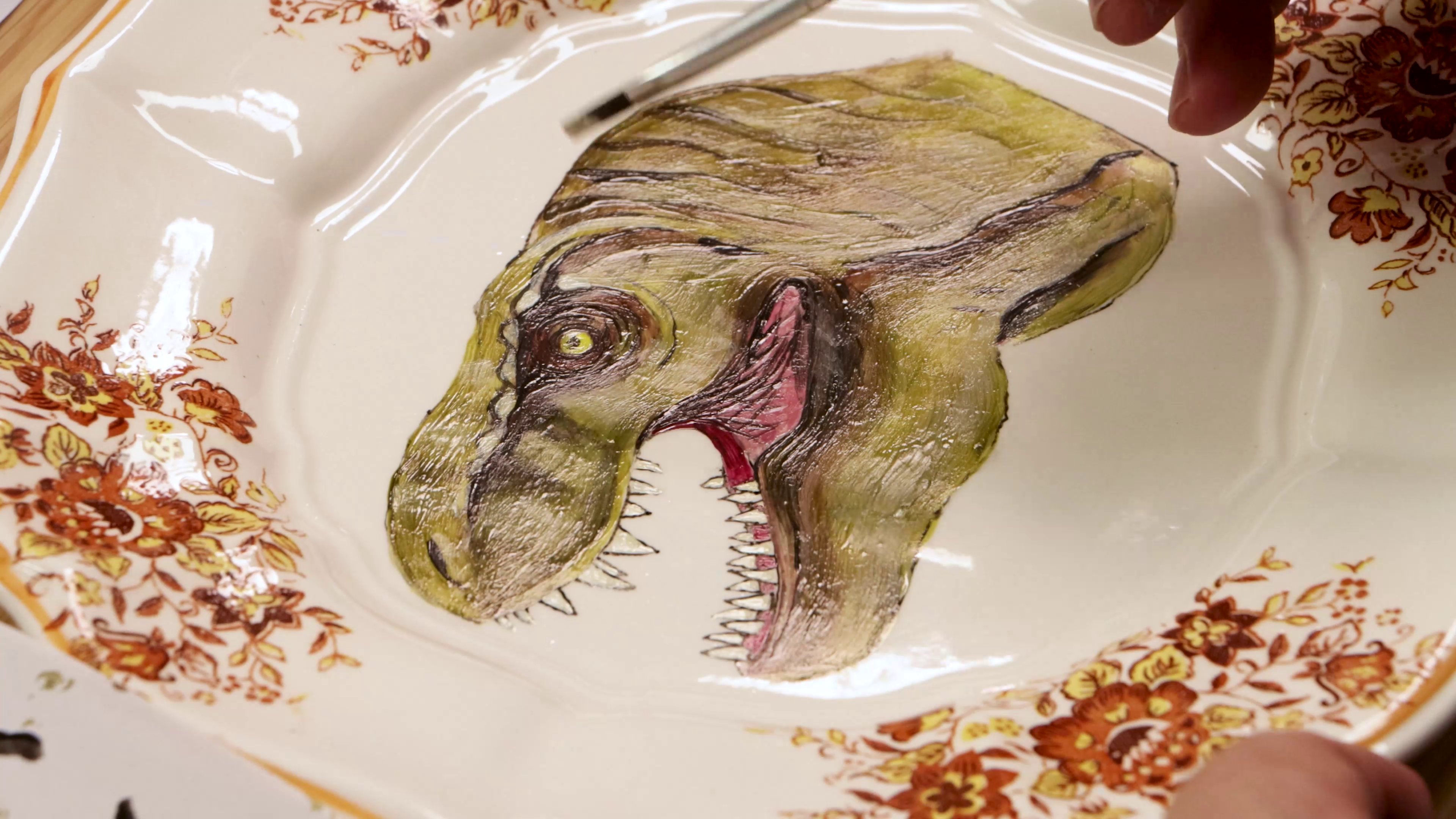 Close up of dinosaur painted onto plate