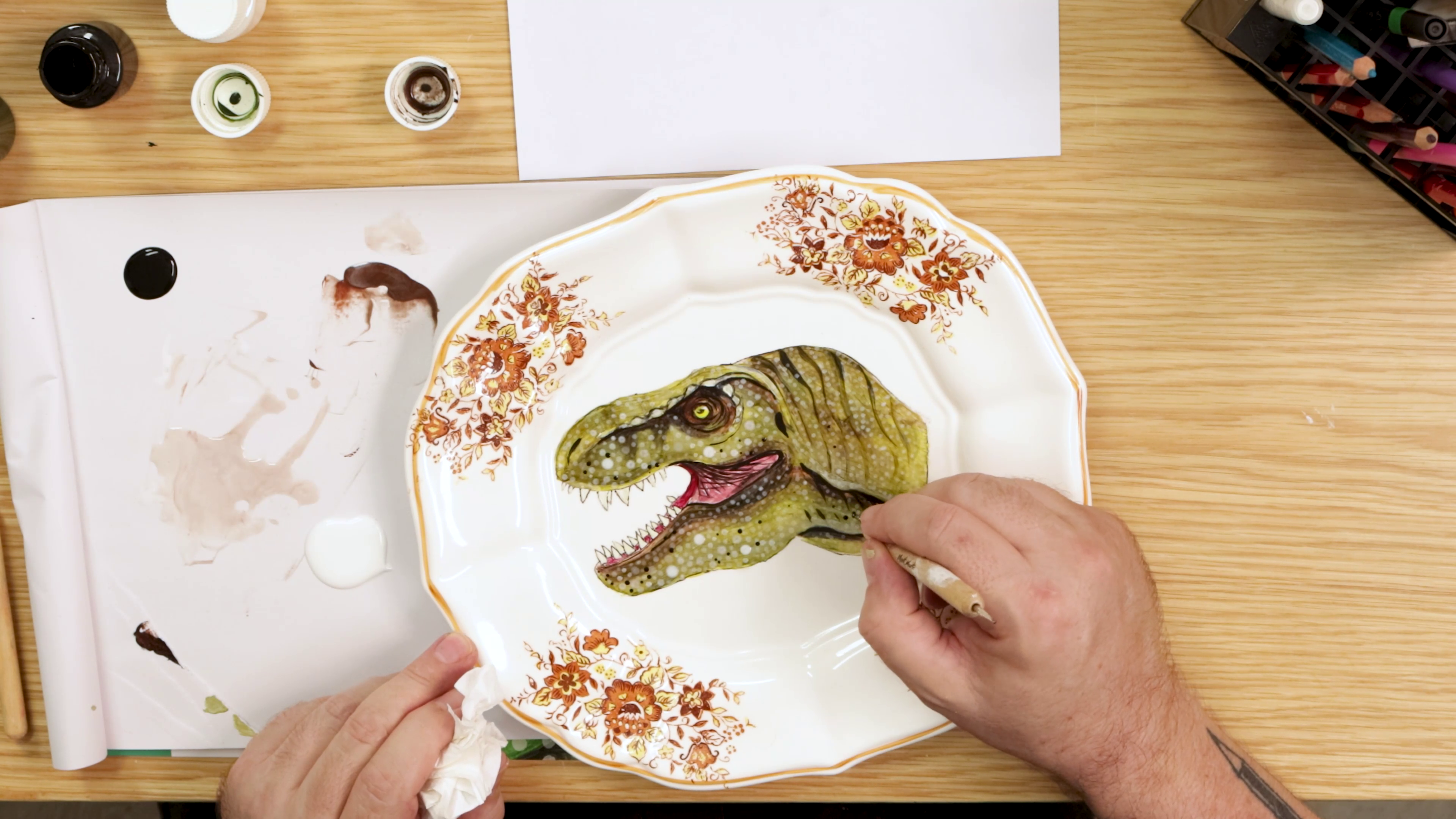Dotting scales onto painted dinosaur