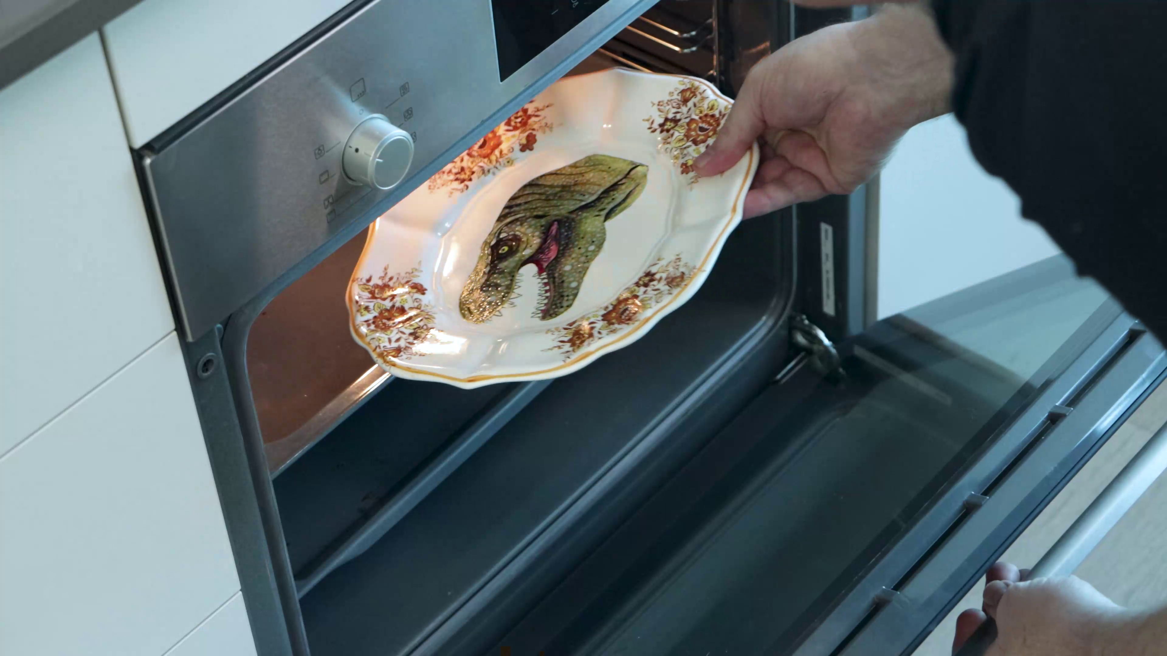 Putting dino thrift plate into open oven