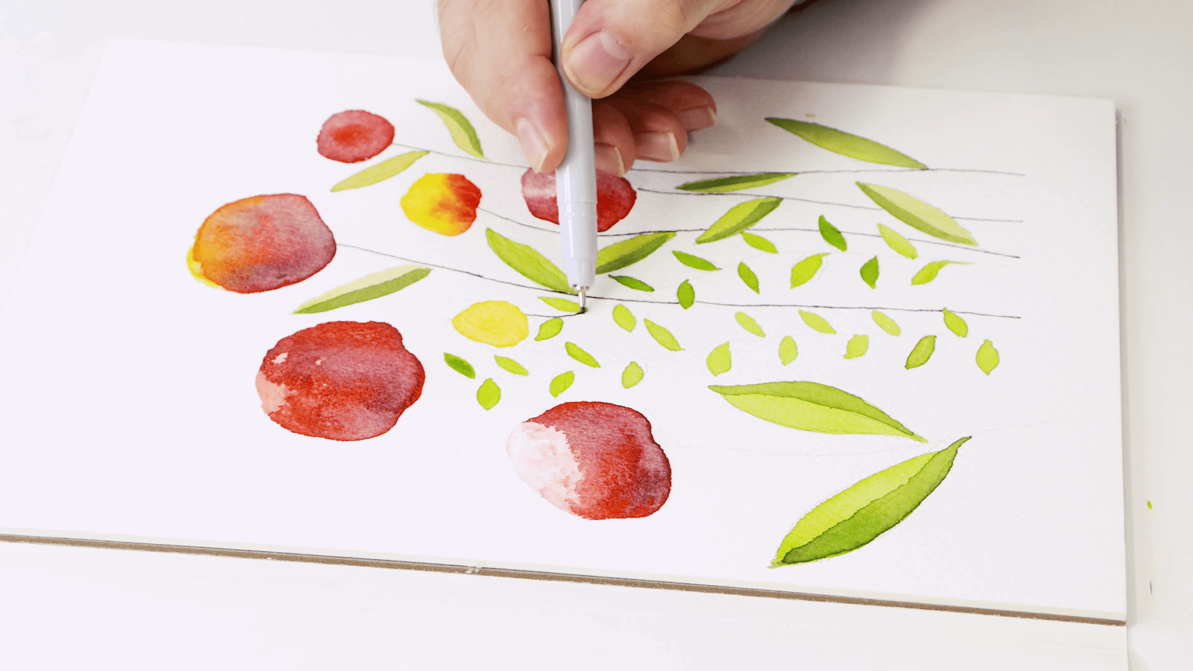 Fineliner marker is used to add definition to the drawing to create stems and details to leaves.