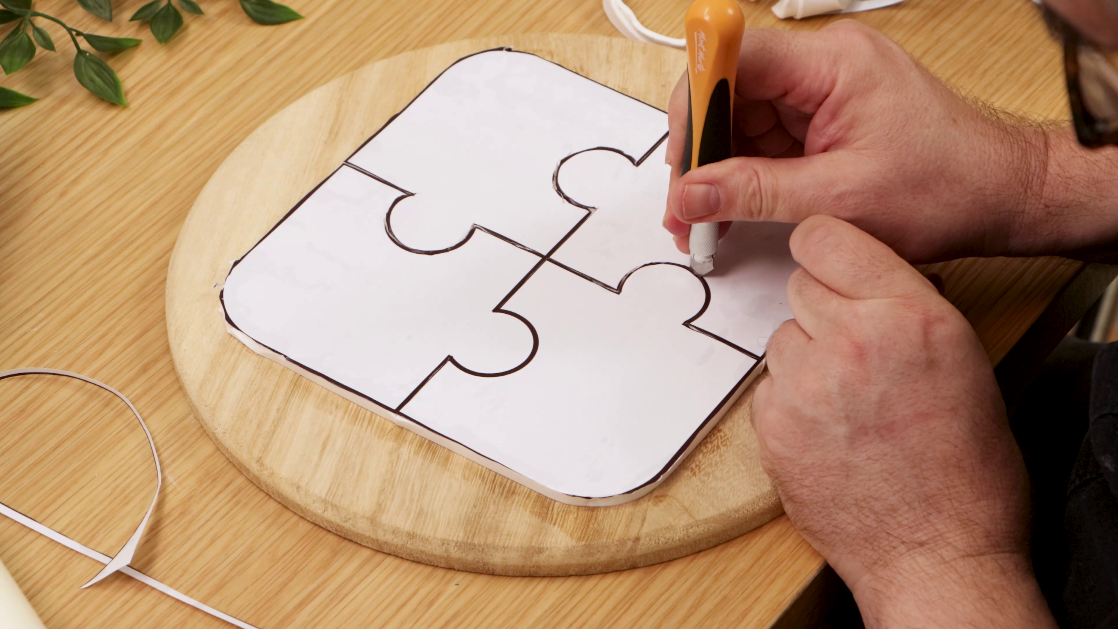 Cutting paper puzzle template on clay