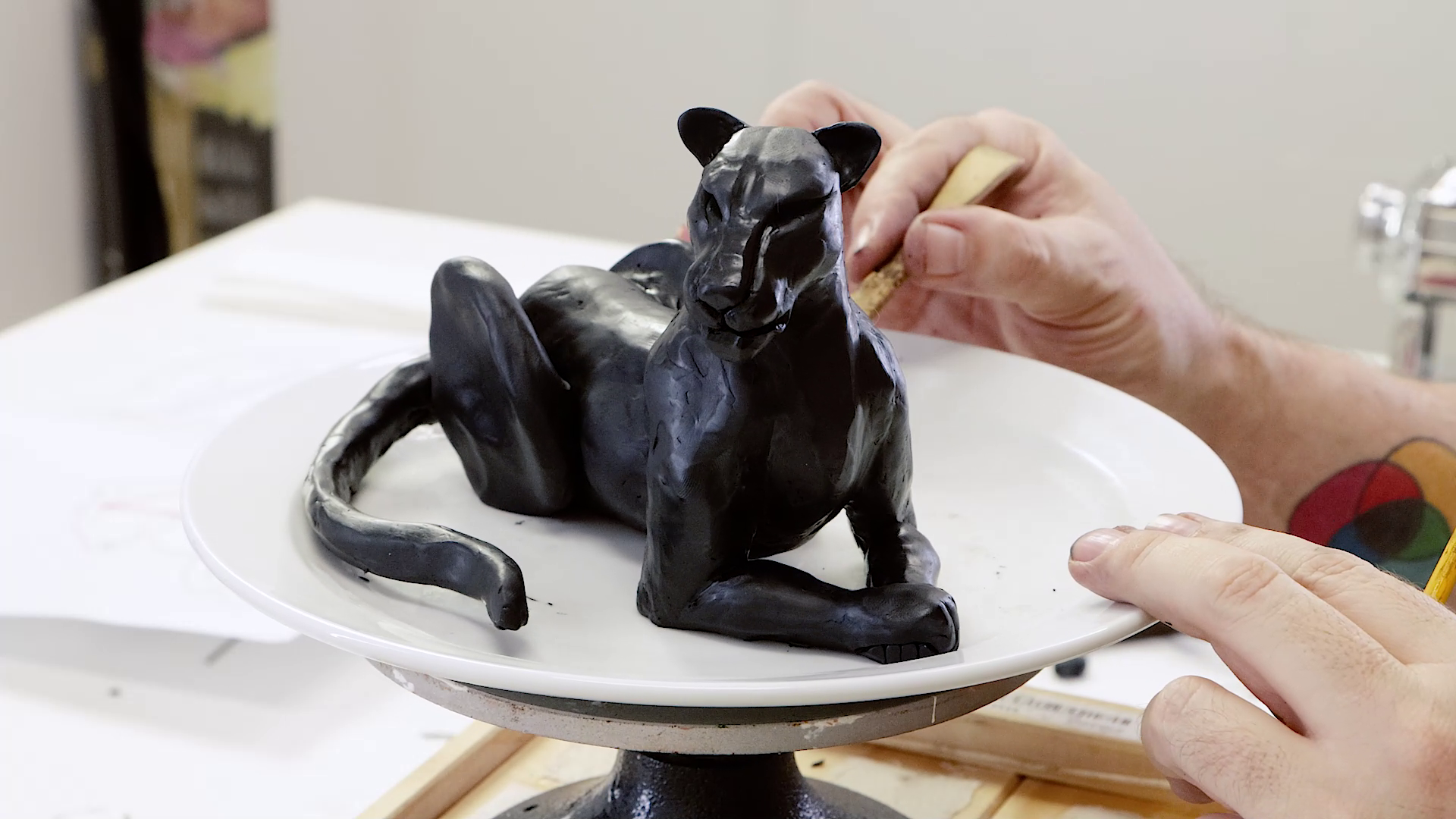 Smoothing out the texture and final touches of the panther sculpture