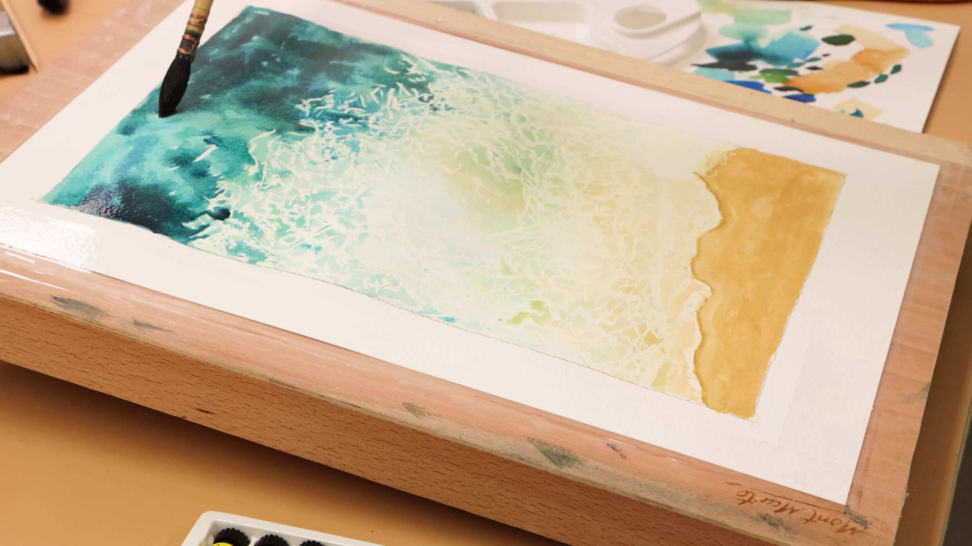 Beach watercolour scene painted over masking fluid foam lines