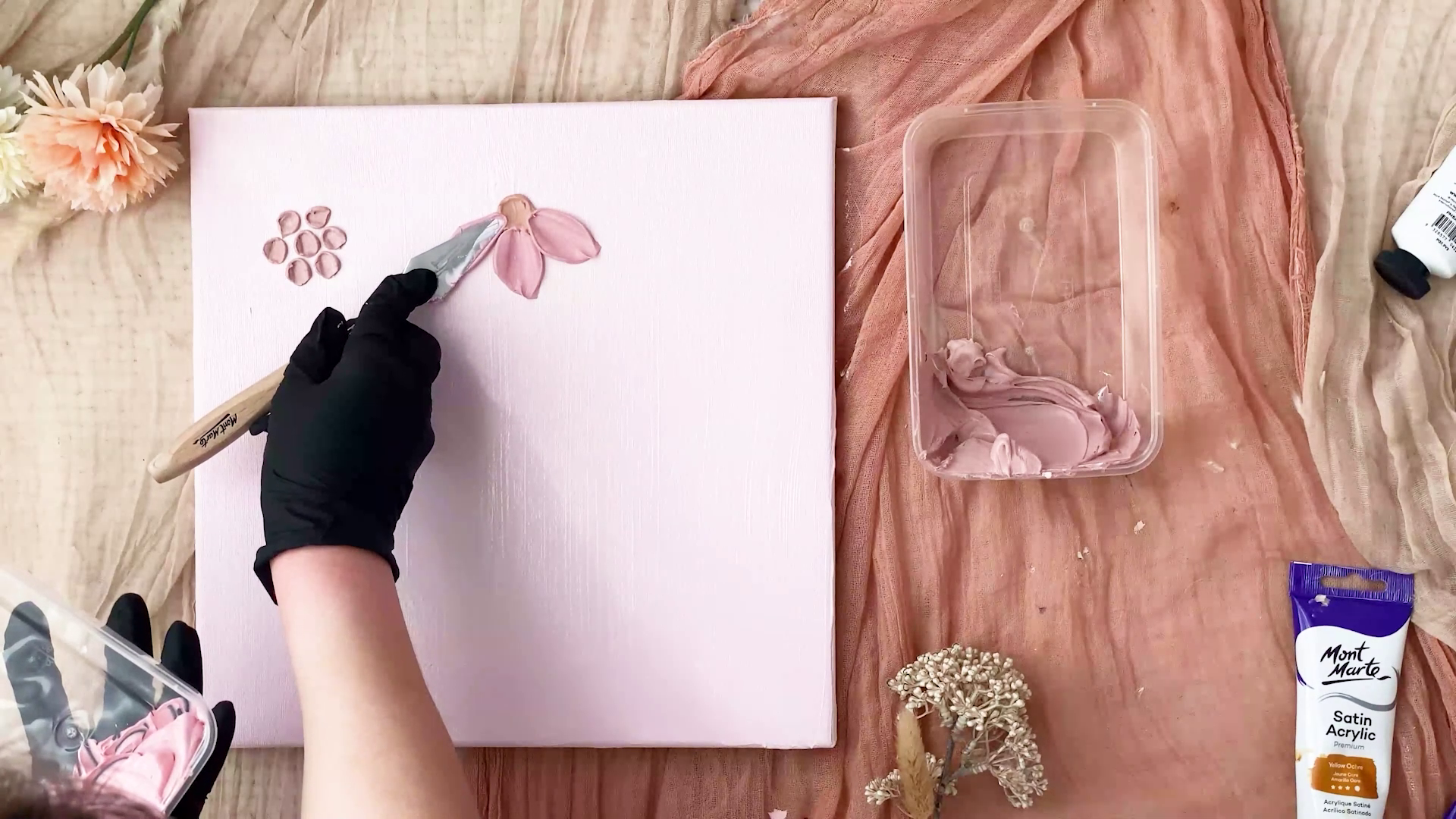 Palette knife flower being applied on pink canvas