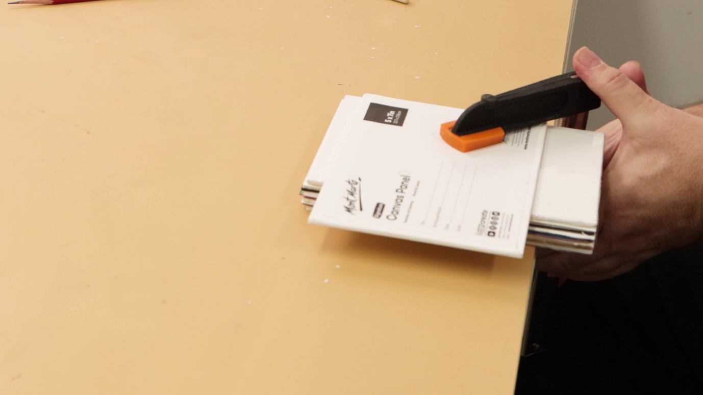 A stapler with a piece of paperDescription automatically generated