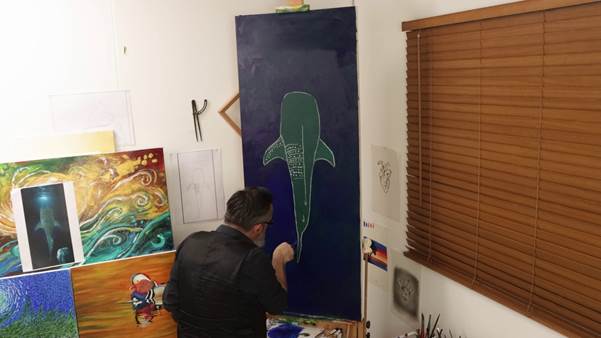 Painting dark blue water around the whale shark sketch