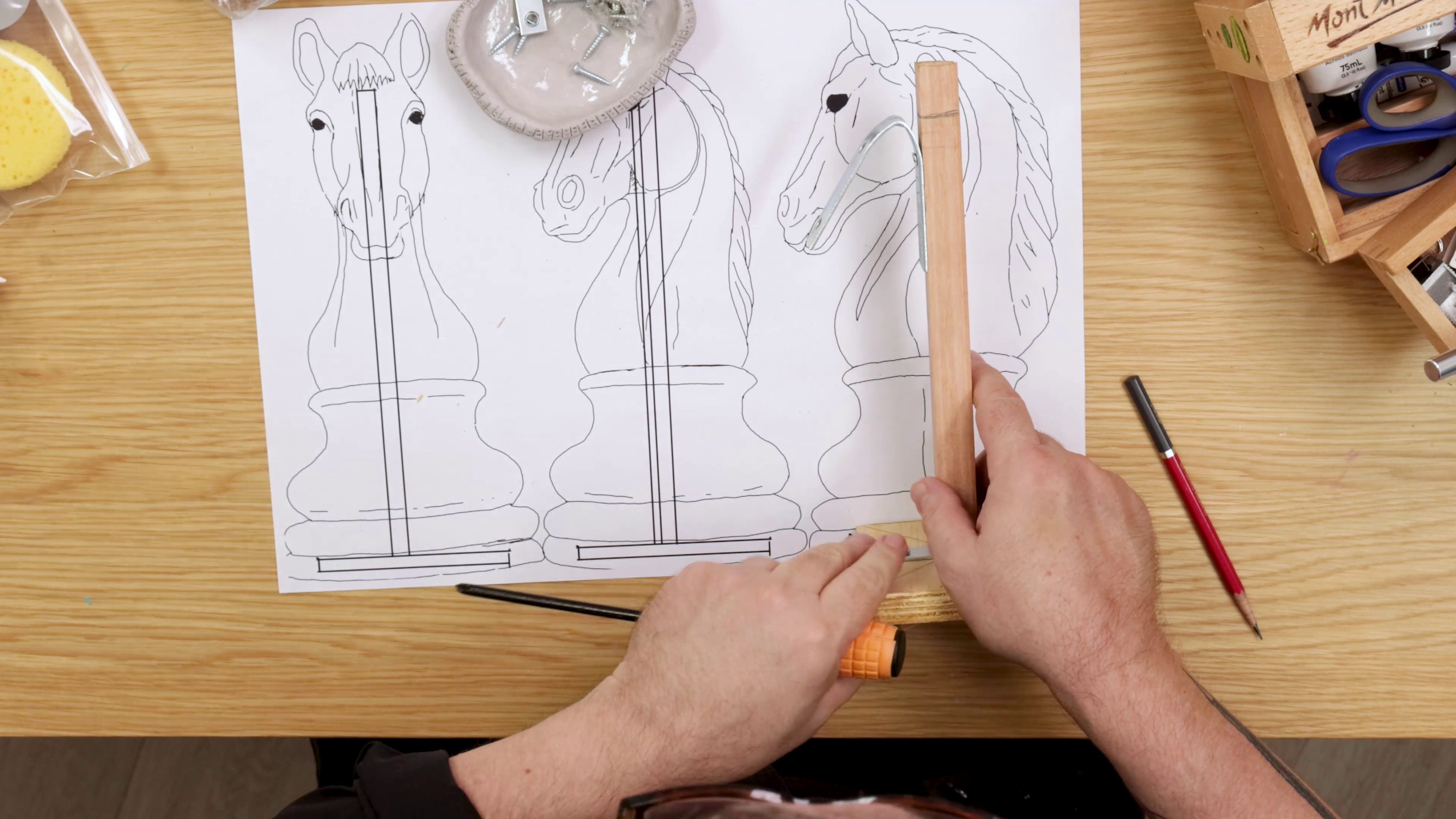 Clay armature on top of chess knight sketch