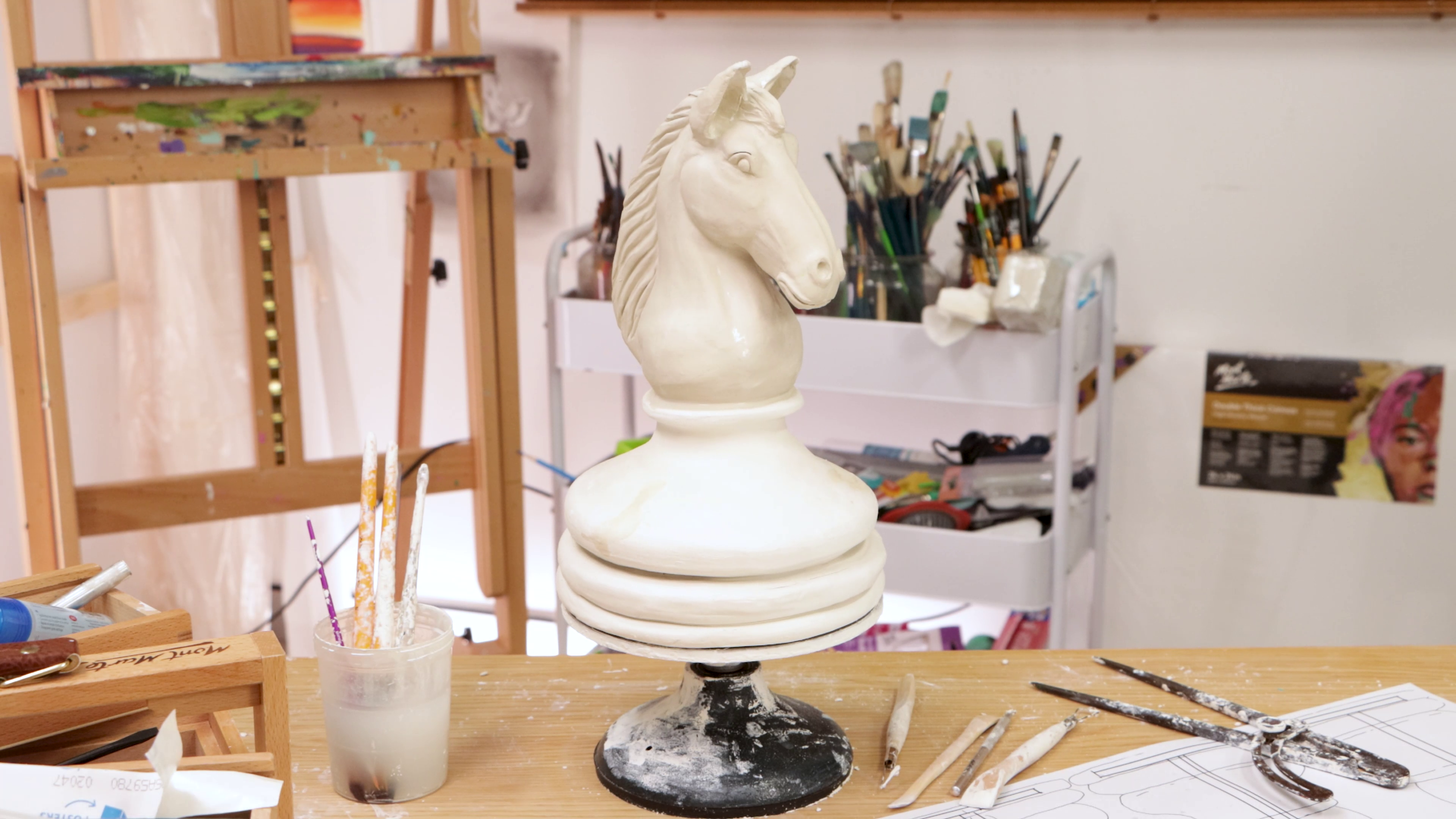 Wide shot of clay horse on pottery wheel