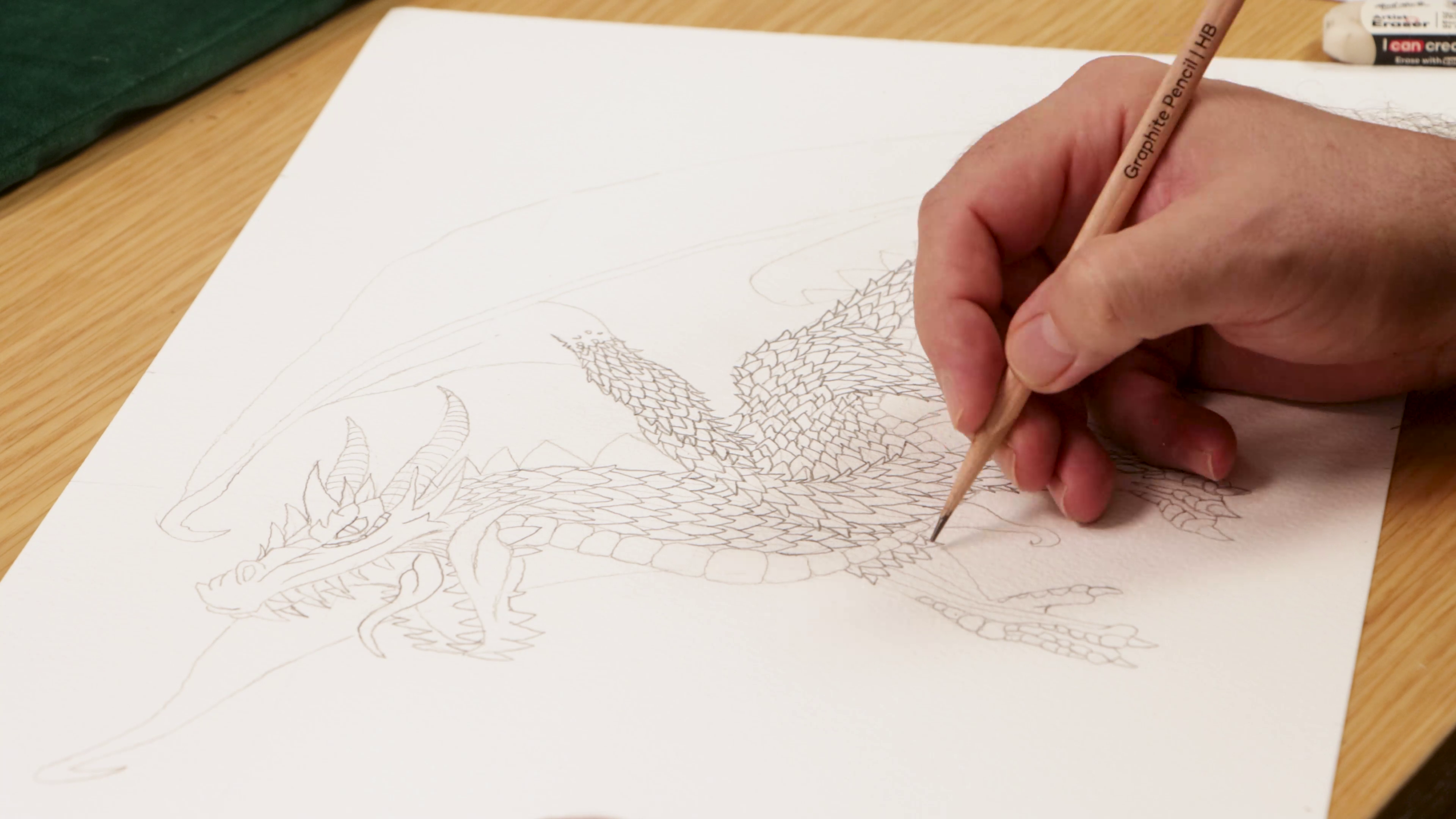 Drawing scales in graphite for dragon sketch