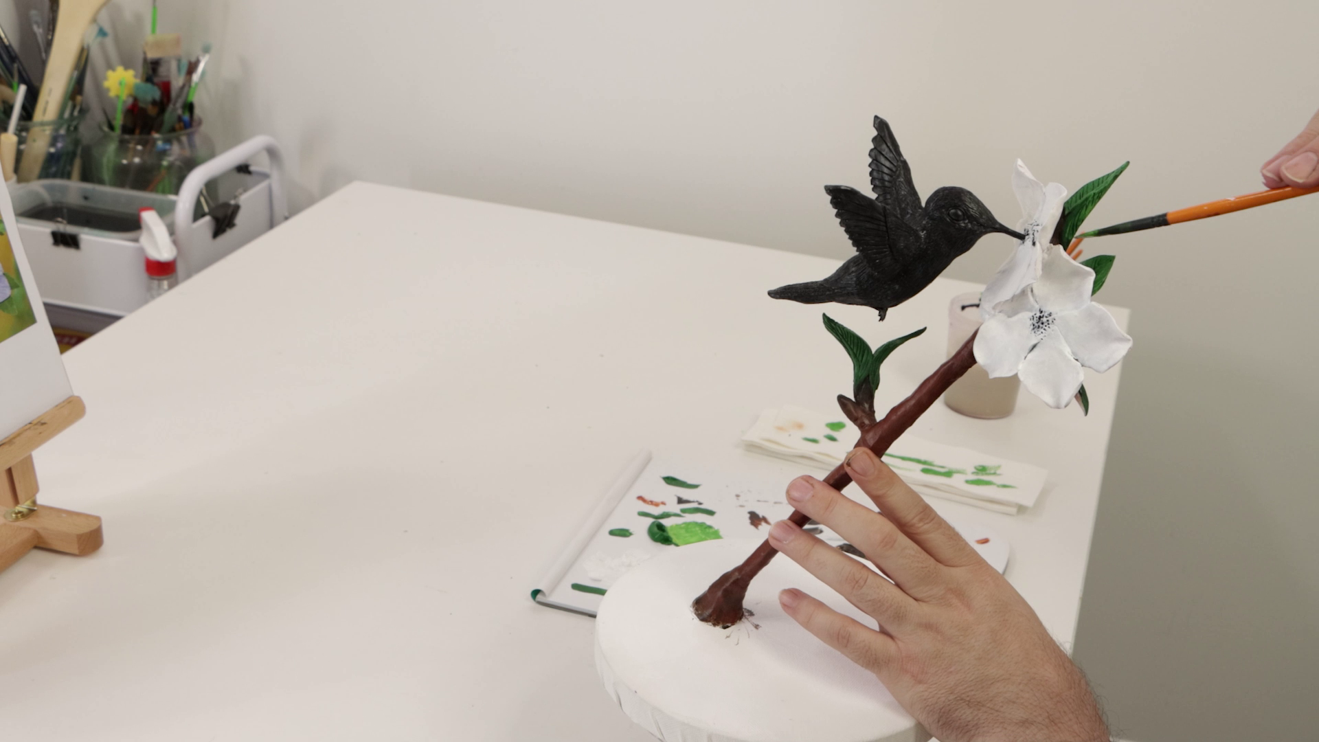 Hummingbird and flower branch sculpture leaves and branch being painted