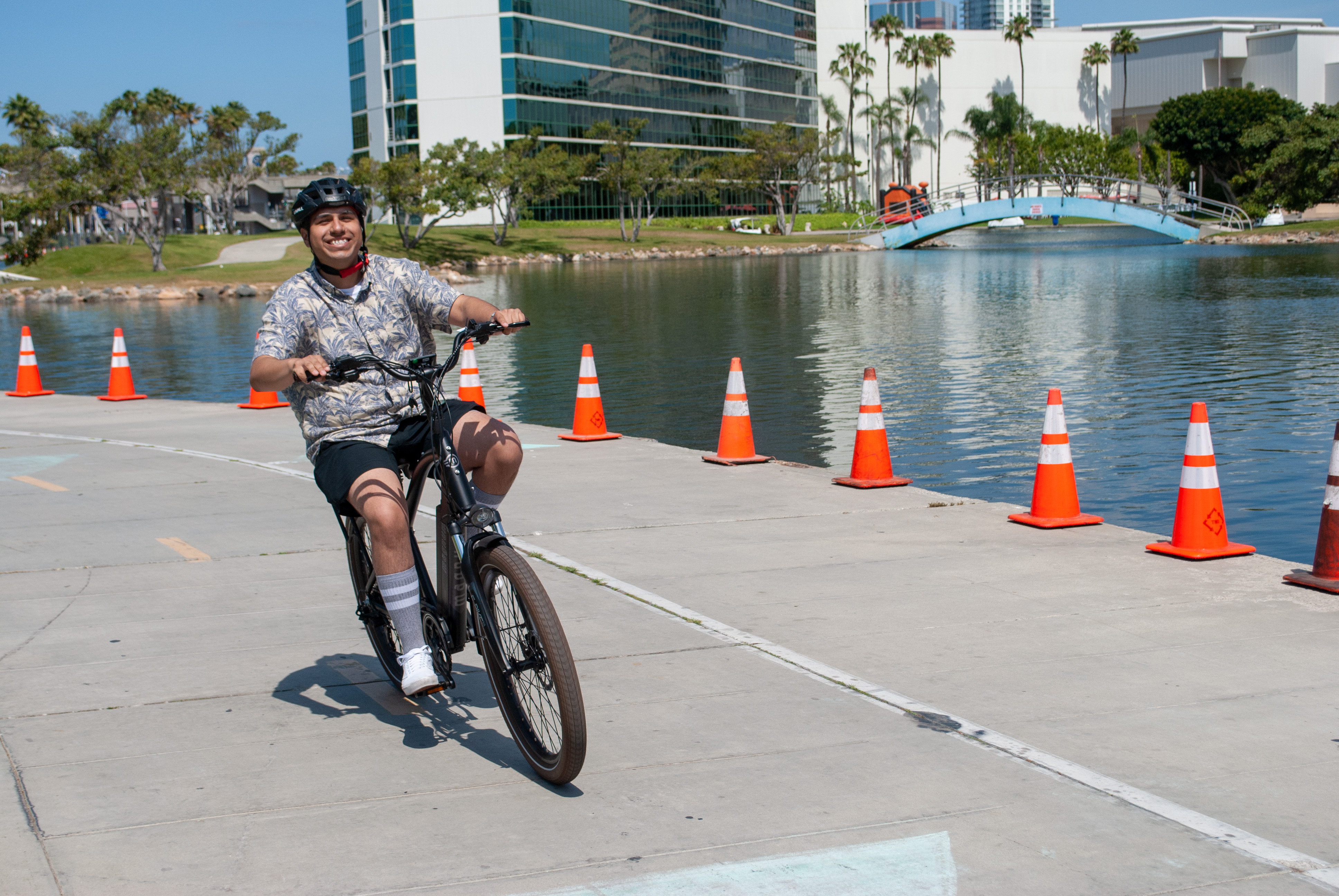 Magnum Bikes test ride outdoor concrete path with water bridge and buildings