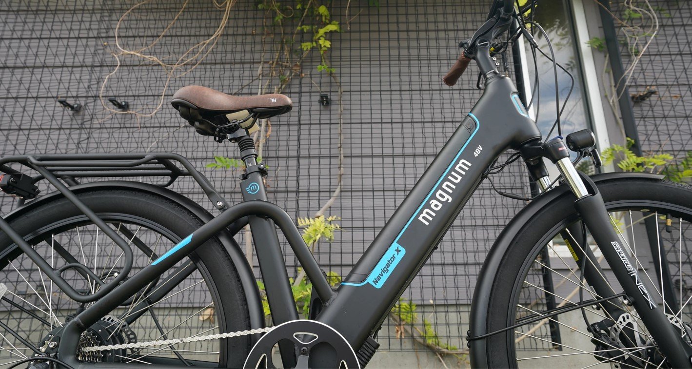 Magnum Navigator X electric bike parked in front of wire trellis with plants