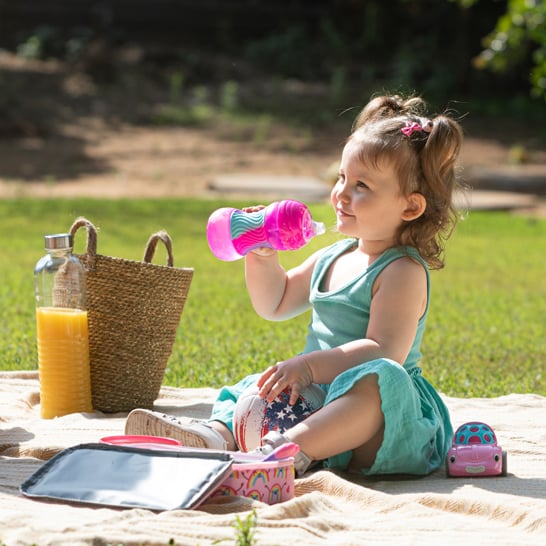 Toddler drinking from a pink sippy cup