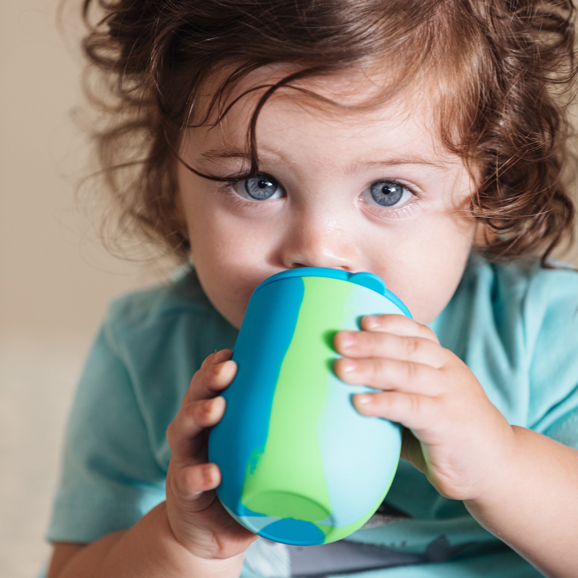 Small child drinking from cup