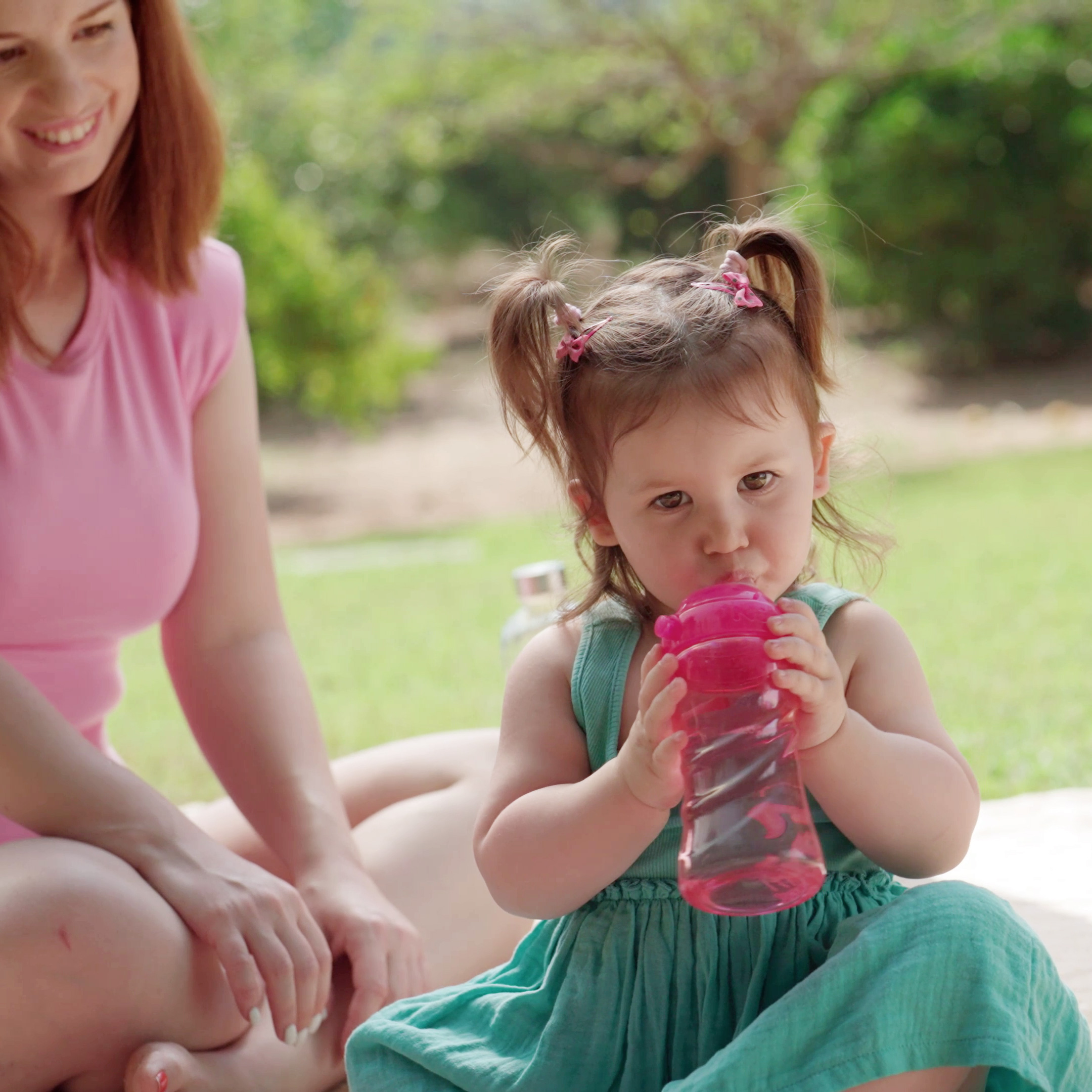 Child drinking from Nuby bottle in the outdoor