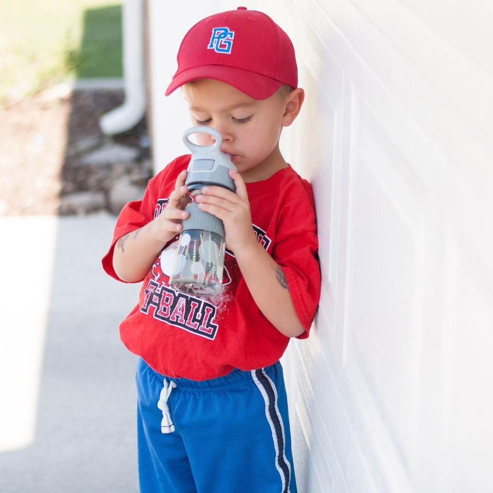 Child drinking from bottle in the outdoor