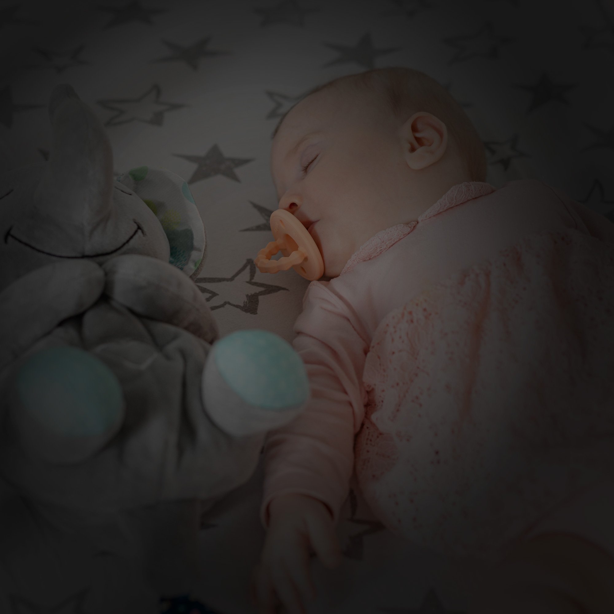 Baby sleeping with stuff animal & teether