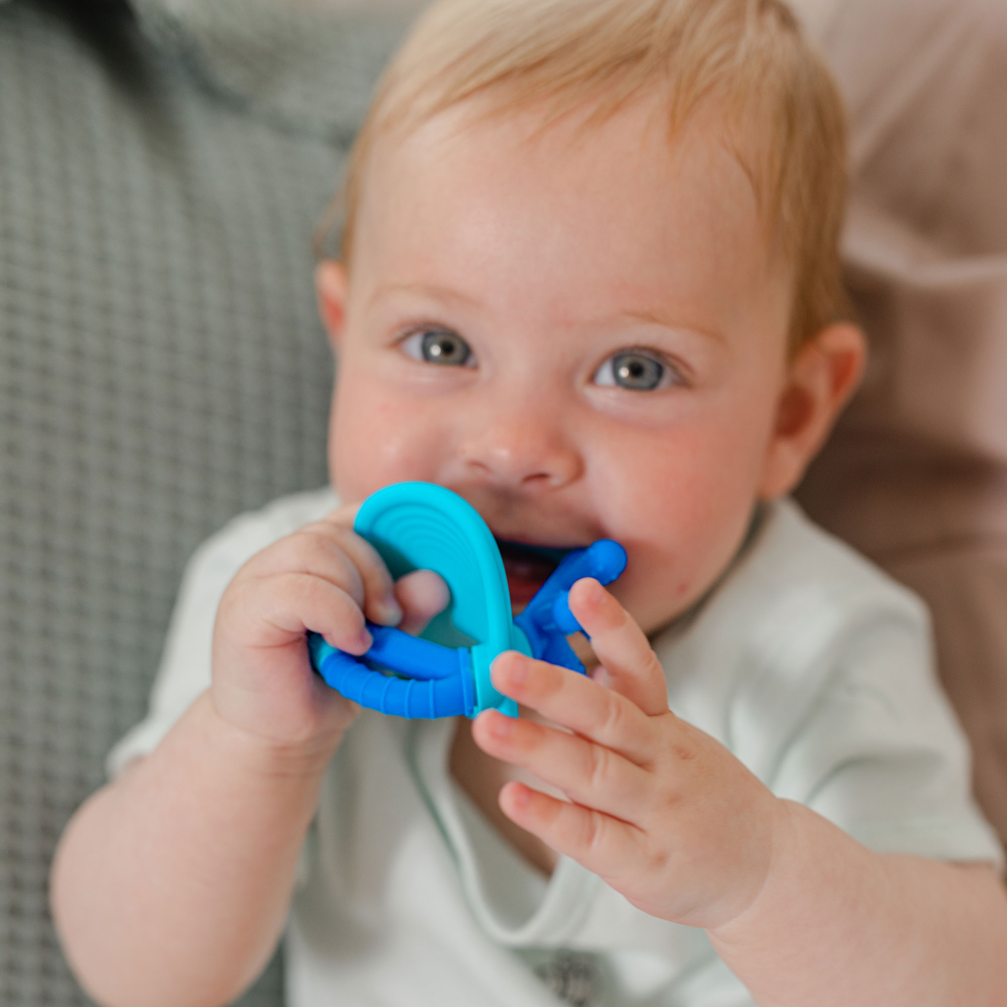 baby chewing on teether