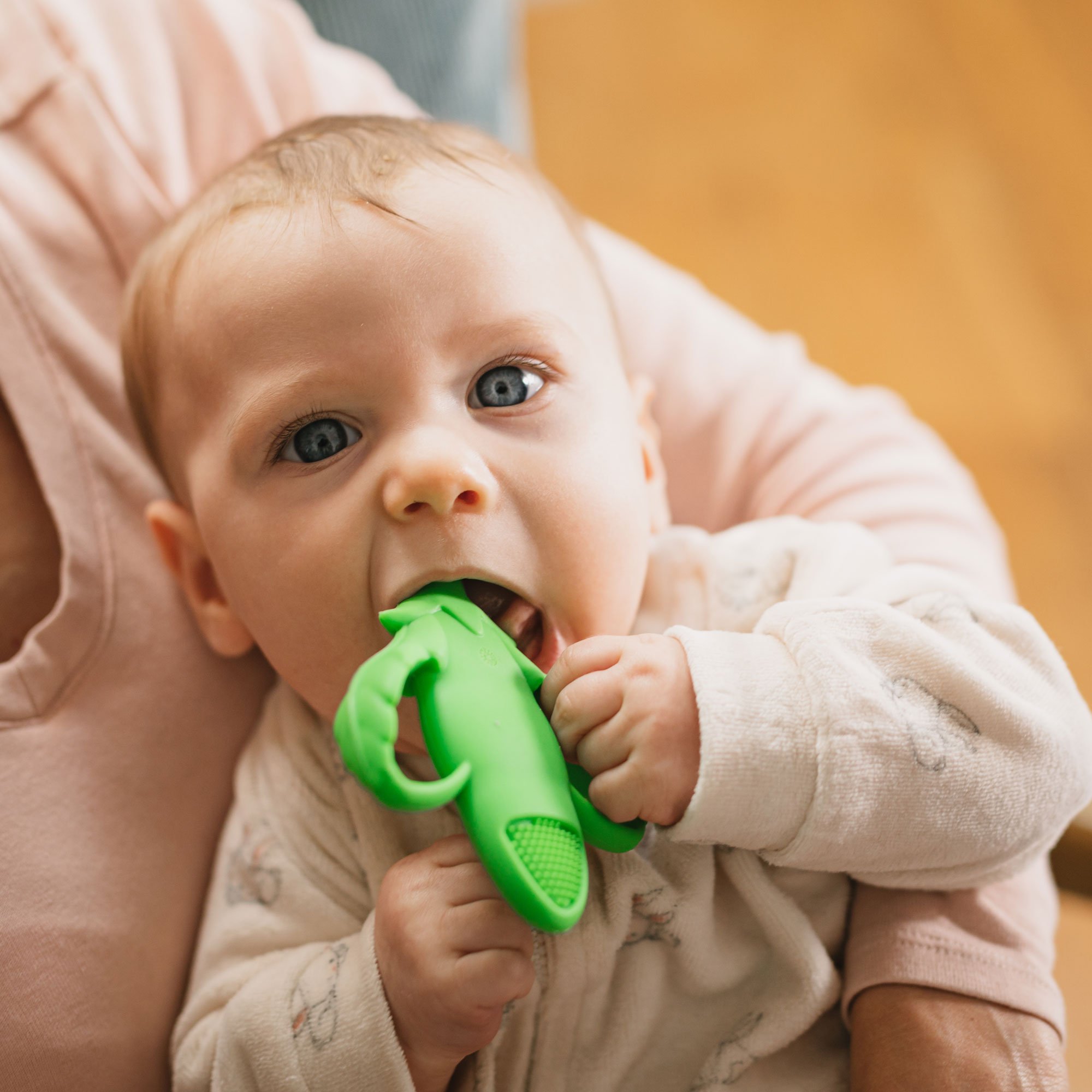 baby with green teether