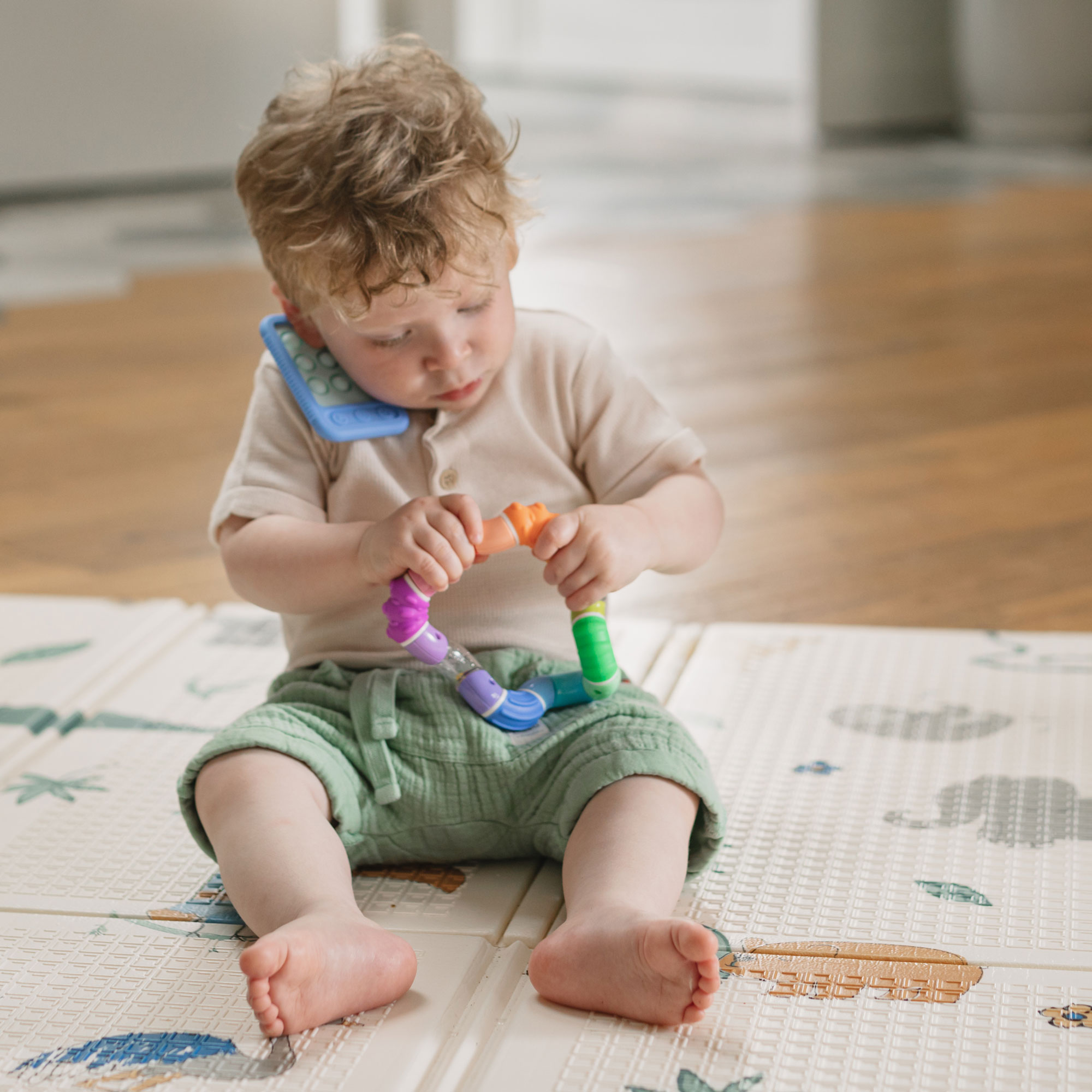 Boy playing with toys on the floor