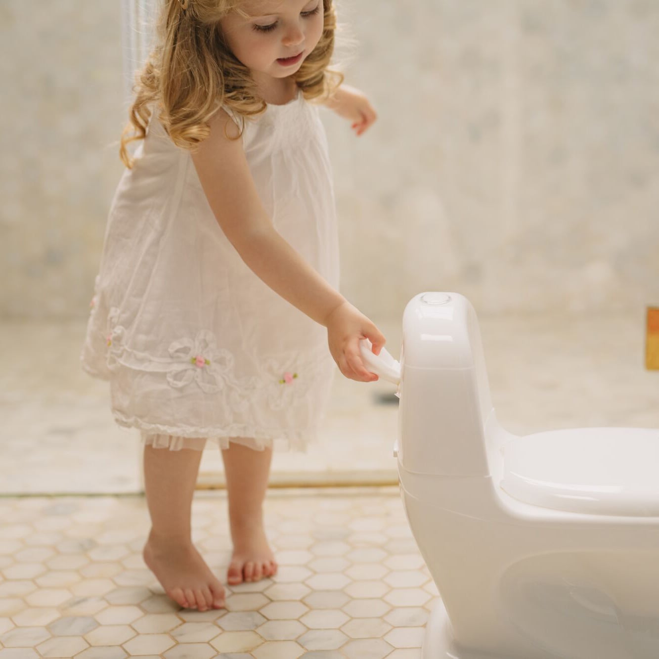 Toddler using the My Real Potty from Nuby.