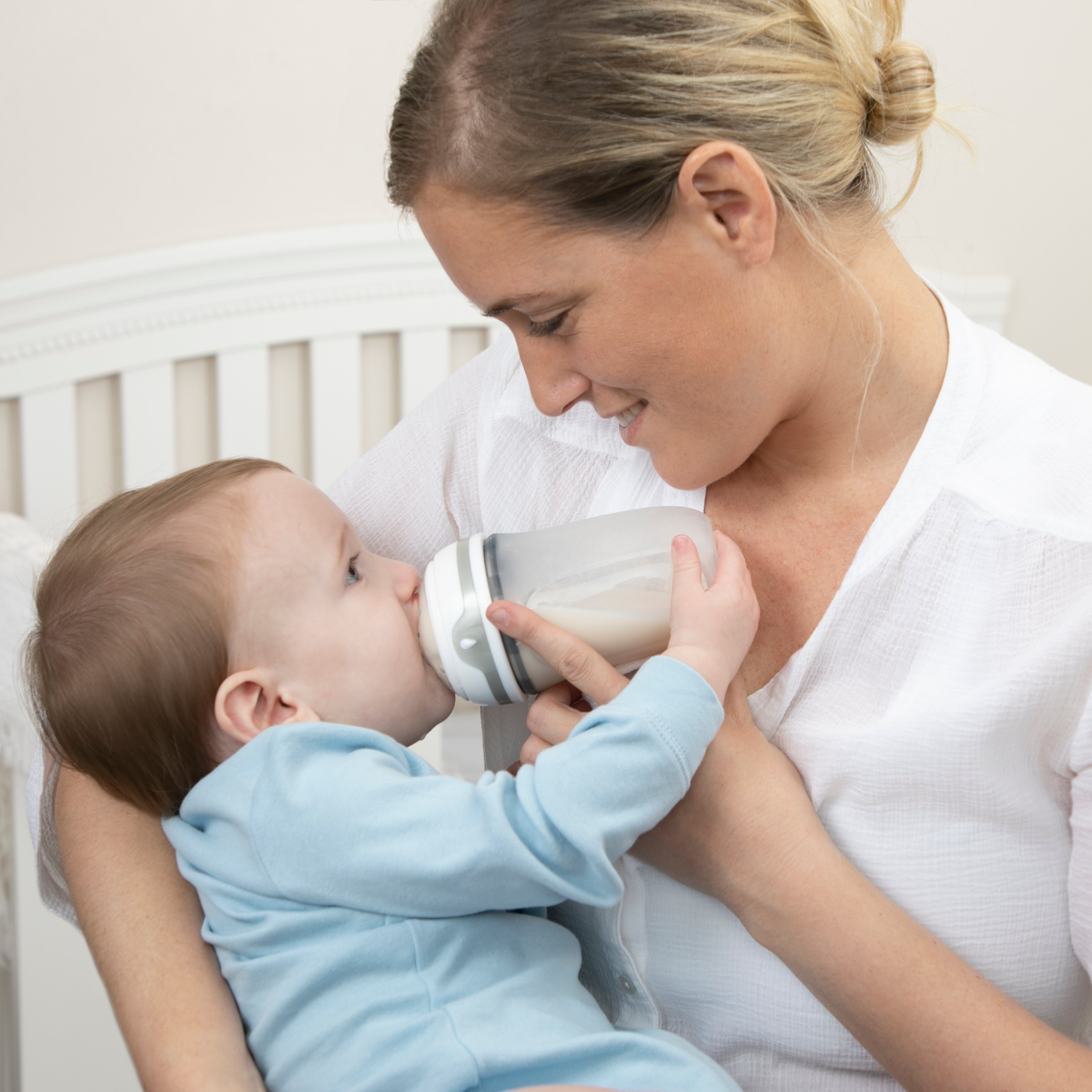 Mom feeding a baby with an anti-colic bottle