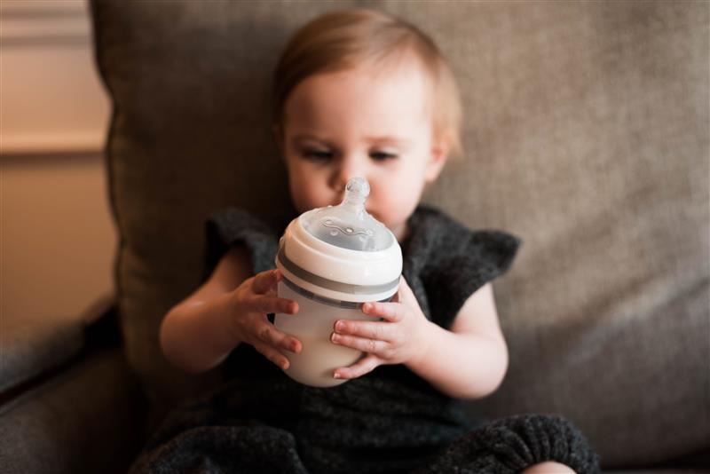 Baby holding silicone bottle