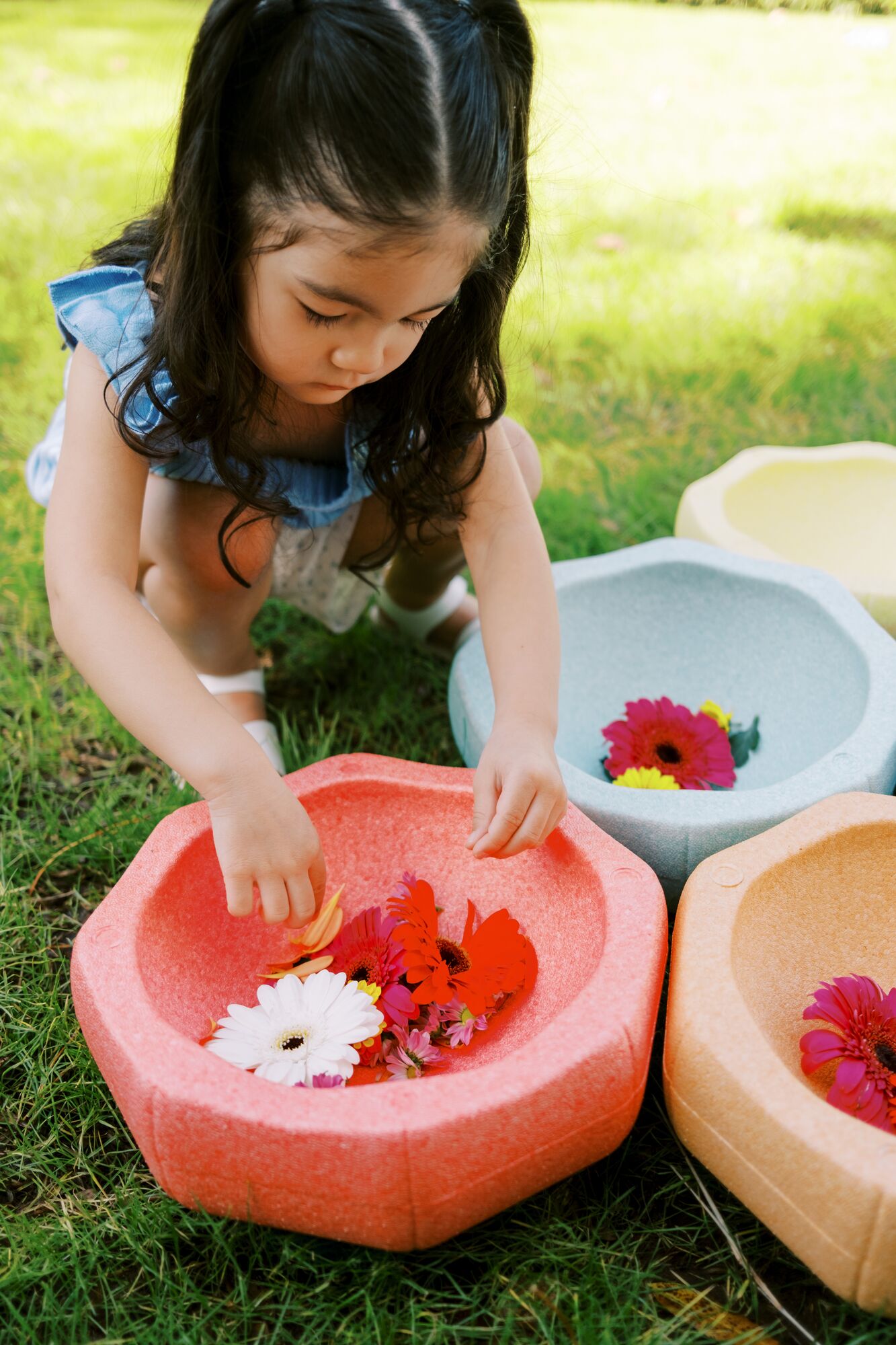 Child playing flower soup game with Nuby StepPebbles.