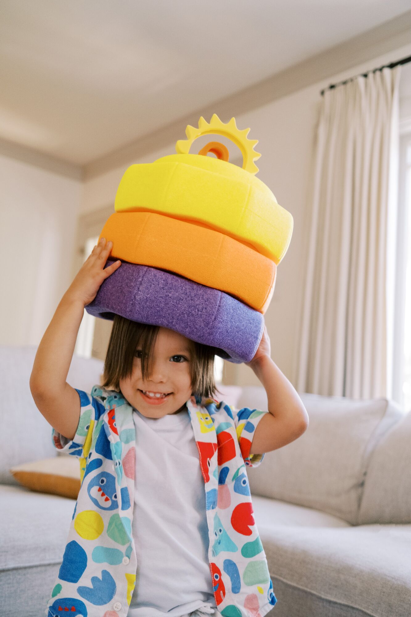Child playing stack game with Nuby StepPebbles.