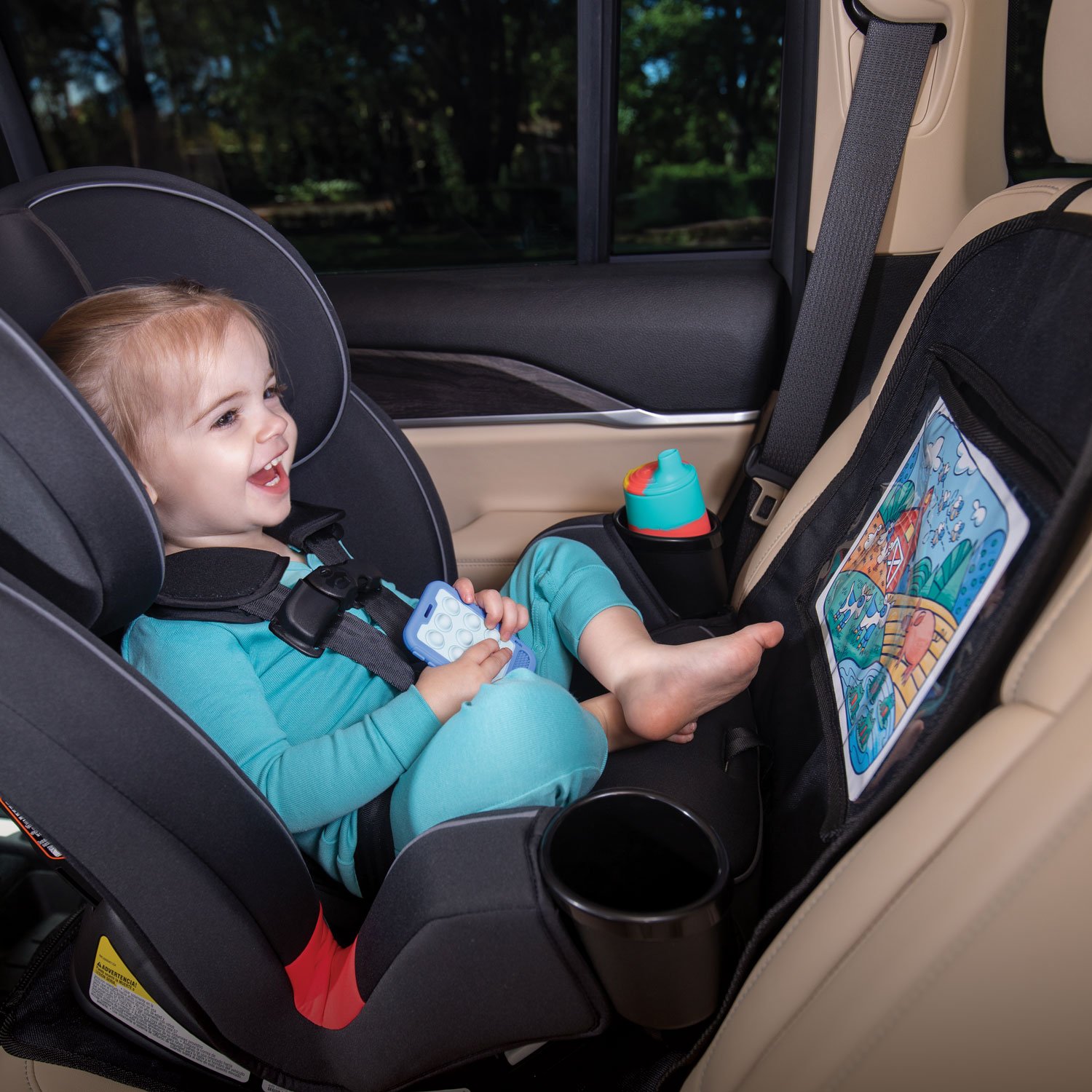 Toddler in rear facing car seat with Nuby x Safe in the Seat protective seat cover.