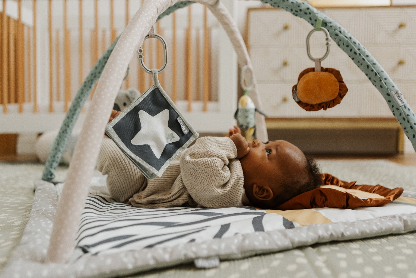 A baby lying on a blanketDescription automatically generated