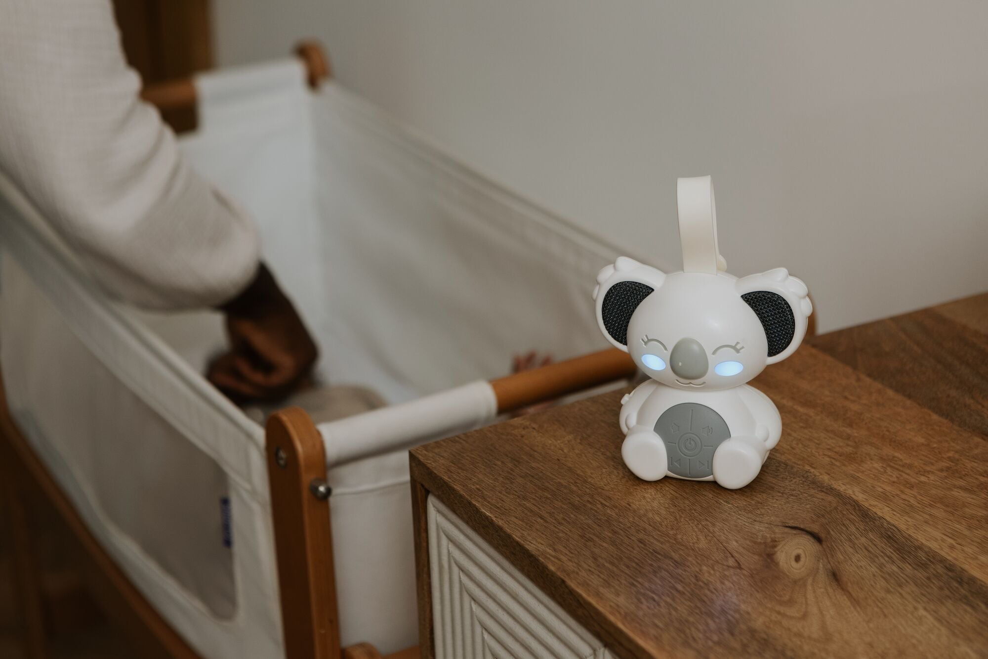 Nuby Sydney Sound Bear sleep aid next to a crib