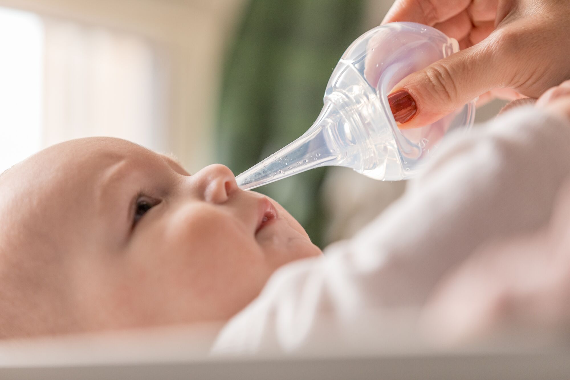 A baby being fed by a nasal aspiratorDescription automatically generated