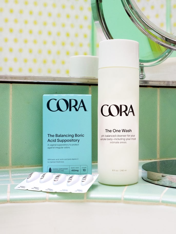 Cora Boric Acid Suppository and cleanser product sitting upright in a bathroom