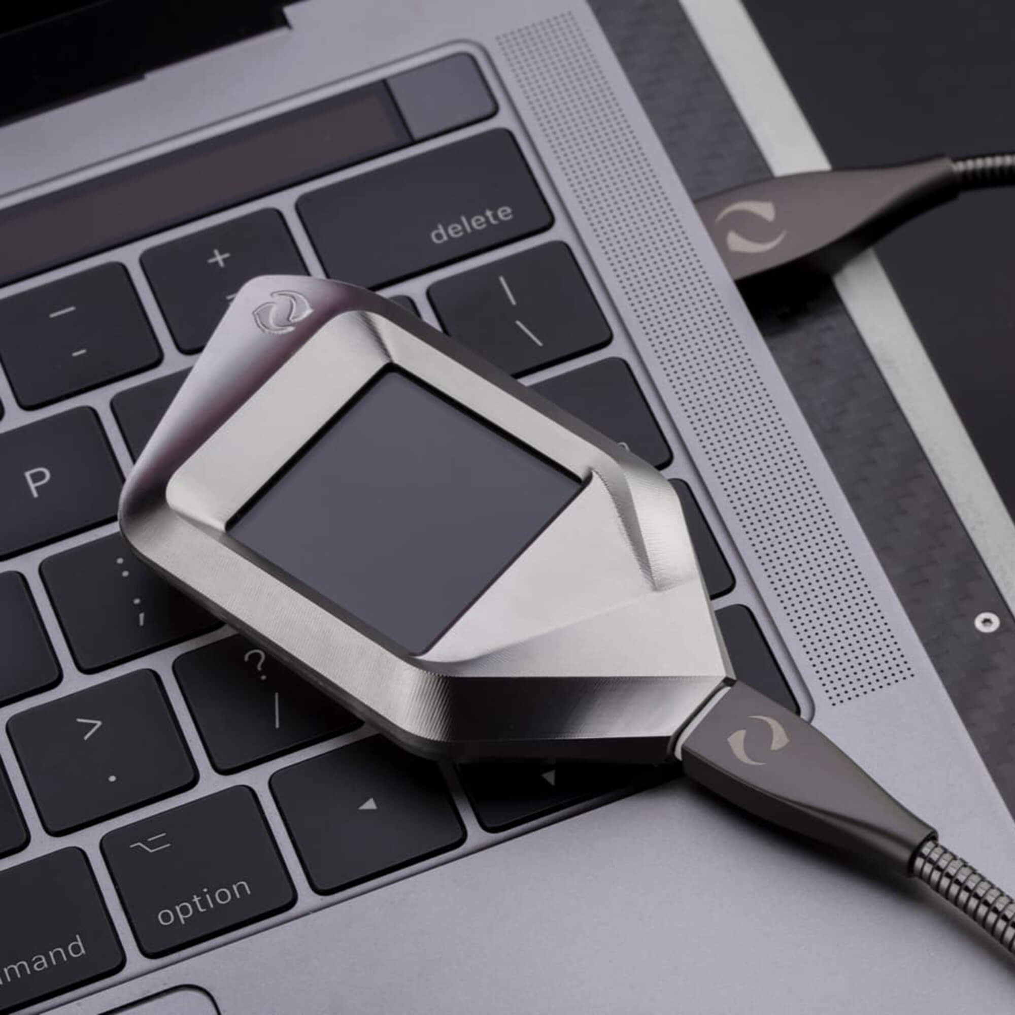 Gray CORAZON wallet on a laptop